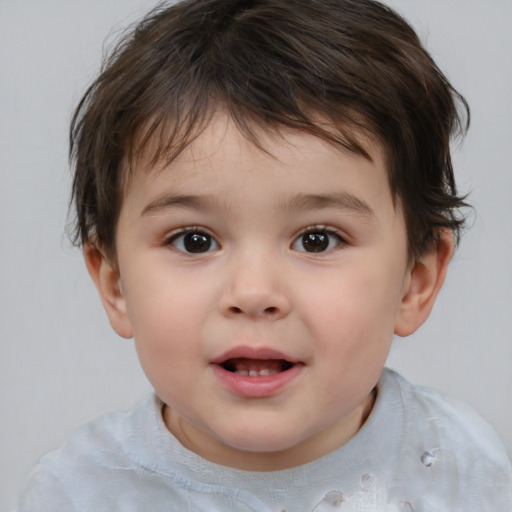 Joyful white child male with short  brown hair and brown eyes