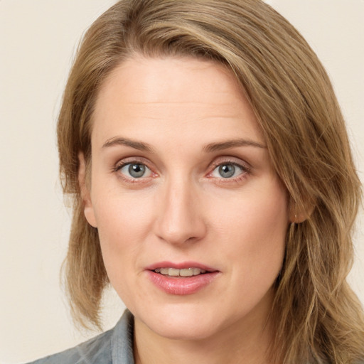 Joyful white young-adult female with medium  brown hair and blue eyes