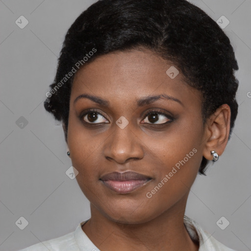 Joyful black young-adult female with short  brown hair and brown eyes