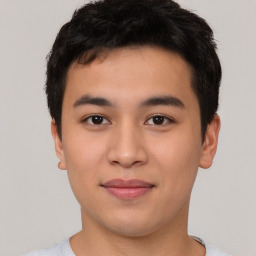 Joyful asian young-adult male with short  black hair and brown eyes