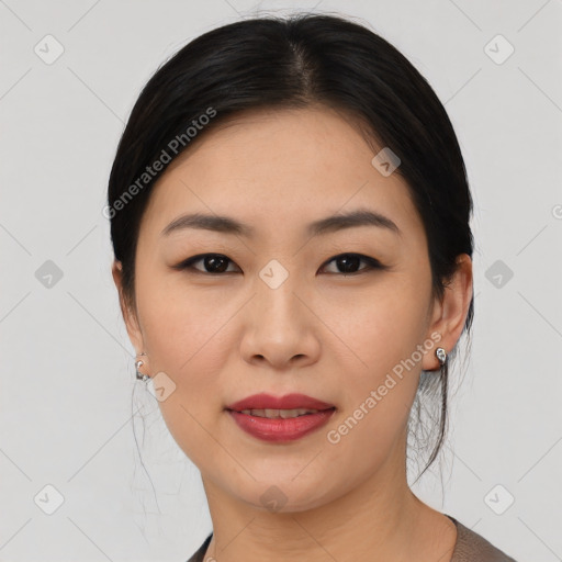 Joyful asian young-adult female with medium  black hair and brown eyes