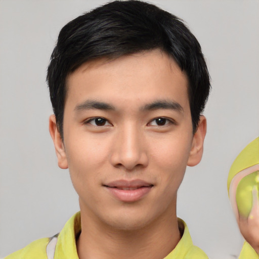 Joyful asian young-adult male with short  black hair and brown eyes