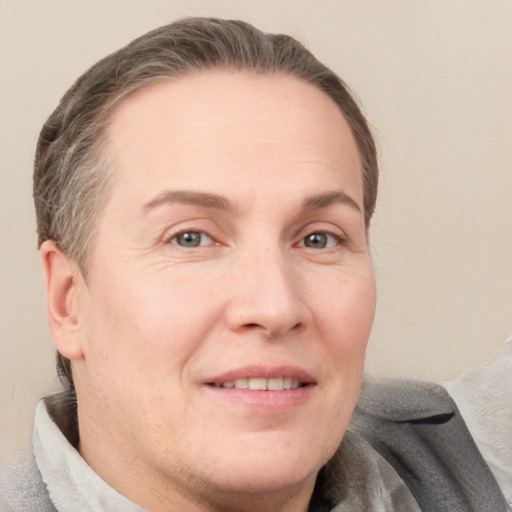 Joyful white adult male with short  brown hair and grey eyes