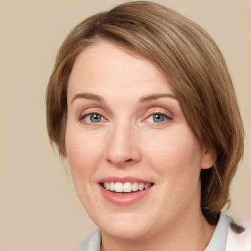 Joyful white young-adult female with medium  brown hair and blue eyes