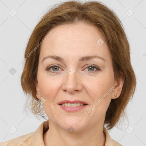 Joyful white adult female with medium  brown hair and grey eyes