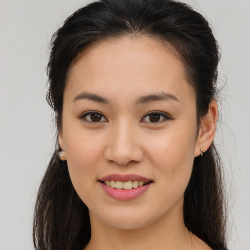 Joyful asian young-adult female with long  brown hair and brown eyes
