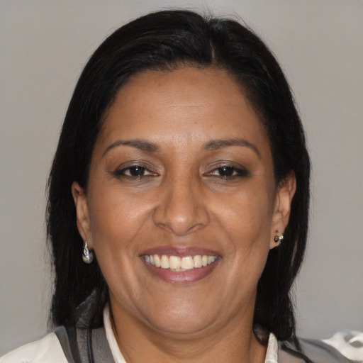 Joyful black adult female with medium  brown hair and brown eyes