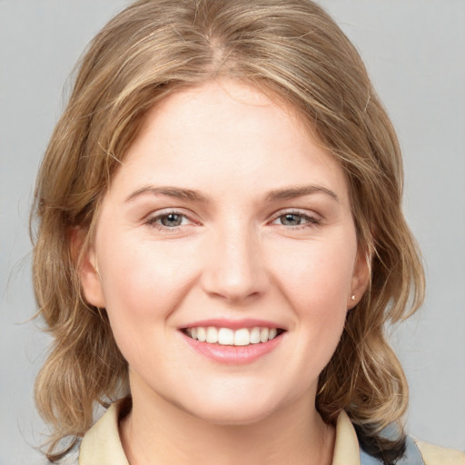 Joyful white young-adult female with medium  brown hair and blue eyes