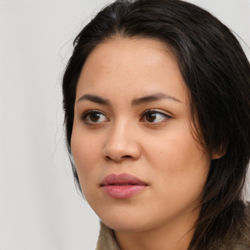 Joyful asian young-adult female with long  black hair and brown eyes