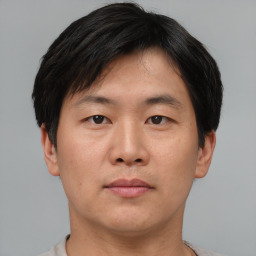 Neutral asian young-adult male with short  brown hair and brown eyes