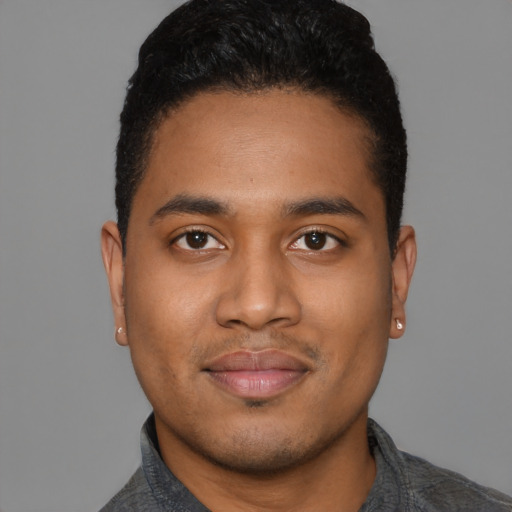 Joyful black young-adult male with short  black hair and brown eyes