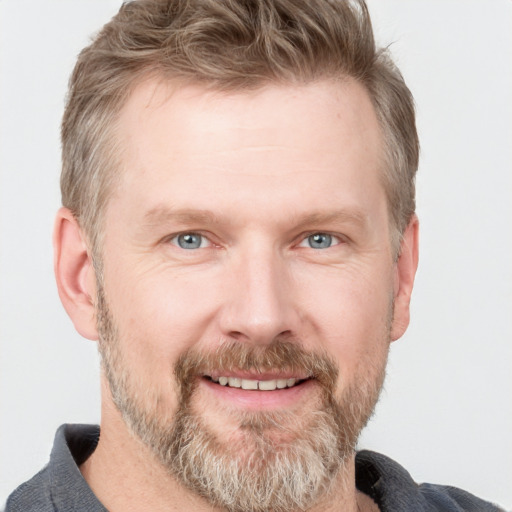 Joyful white adult male with short  brown hair and grey eyes