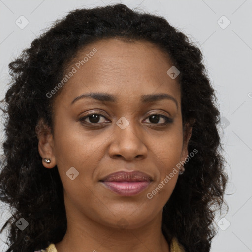 Joyful black adult female with long  brown hair and brown eyes