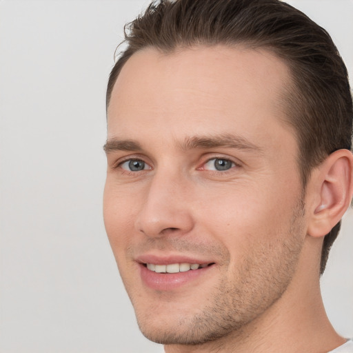 Joyful white young-adult male with short  brown hair and brown eyes