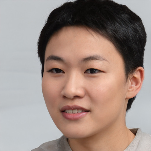 Joyful asian young-adult female with short  black hair and brown eyes