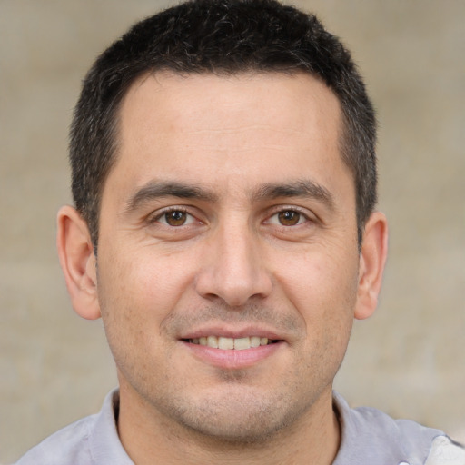 Joyful white adult male with short  brown hair and brown eyes