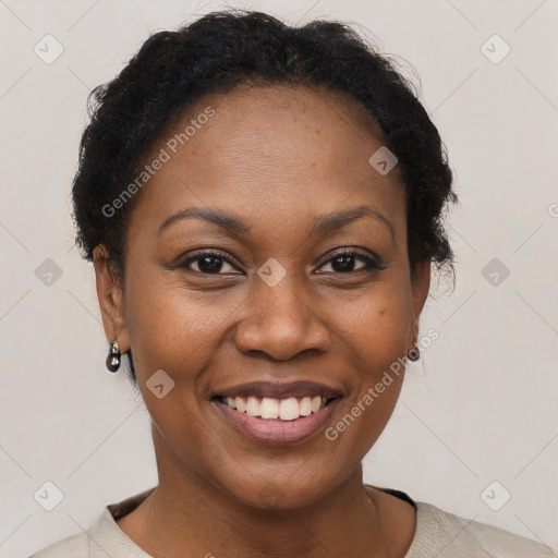 Joyful black young-adult female with short  black hair and brown eyes