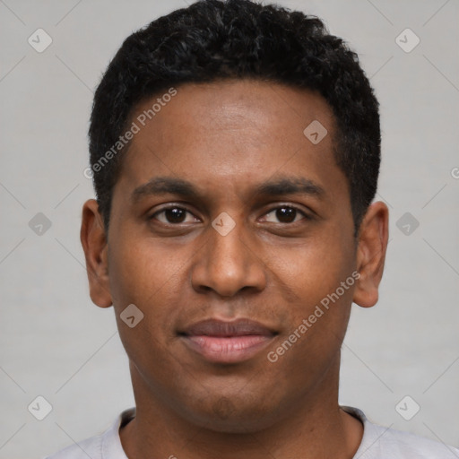 Joyful black young-adult male with short  black hair and brown eyes