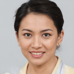 Joyful asian young-adult female with short  brown hair and brown eyes