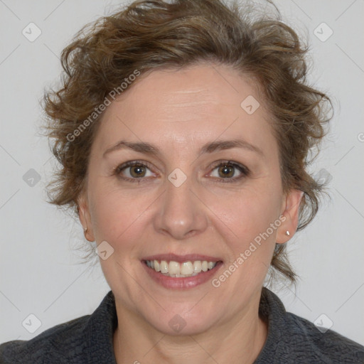 Joyful white adult female with medium  brown hair and blue eyes