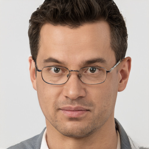 Joyful white adult male with short  brown hair and brown eyes