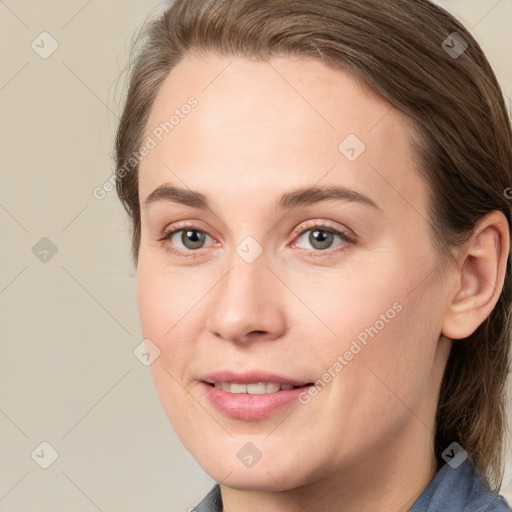 Joyful white young-adult female with medium  brown hair and blue eyes