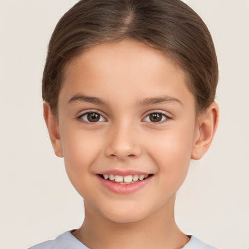 Joyful white child female with short  brown hair and brown eyes