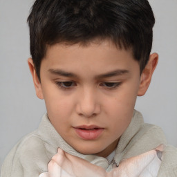 Joyful white child male with short  brown hair and brown eyes