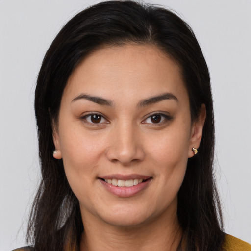 Joyful latino young-adult female with long  brown hair and brown eyes