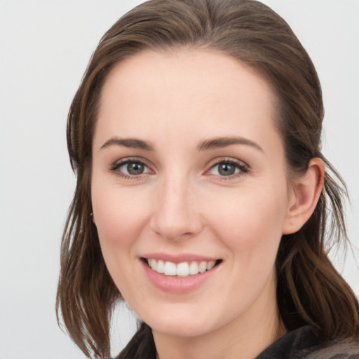 Joyful white young-adult female with medium  brown hair and grey eyes