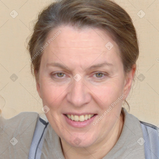 Joyful white adult female with medium  brown hair and blue eyes