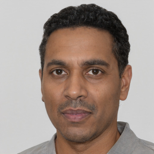 Neutral black adult male with short  black hair and brown eyes