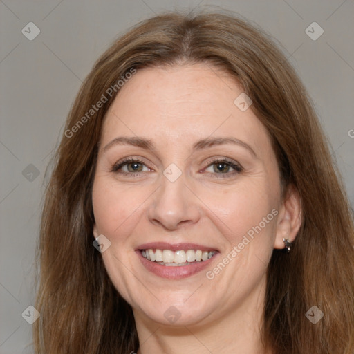 Joyful white adult female with long  brown hair and grey eyes