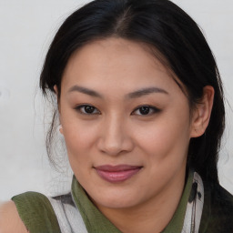 Joyful asian young-adult female with medium  brown hair and brown eyes