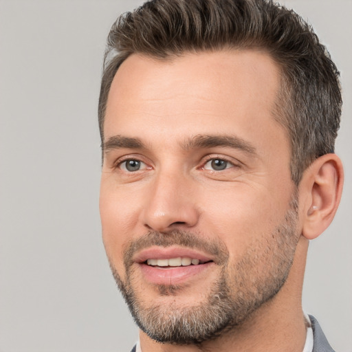 Joyful white adult male with short  brown hair and brown eyes