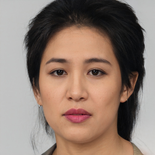Joyful asian young-adult female with medium  black hair and brown eyes