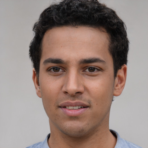 Joyful white young-adult male with short  black hair and brown eyes