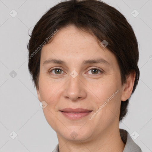 Joyful white adult female with short  brown hair and brown eyes