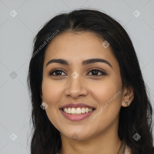 Joyful latino young-adult female with long  brown hair and brown eyes