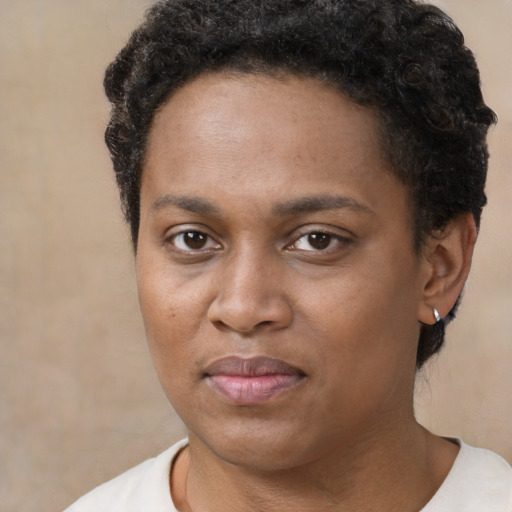 Joyful black young-adult female with short  brown hair and brown eyes