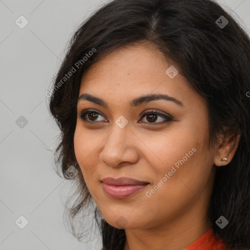 Joyful latino young-adult female with long  brown hair and brown eyes