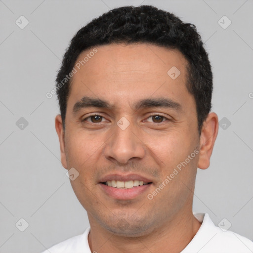 Joyful white young-adult male with short  black hair and brown eyes
