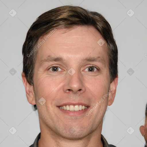 Joyful white adult male with short  brown hair and grey eyes