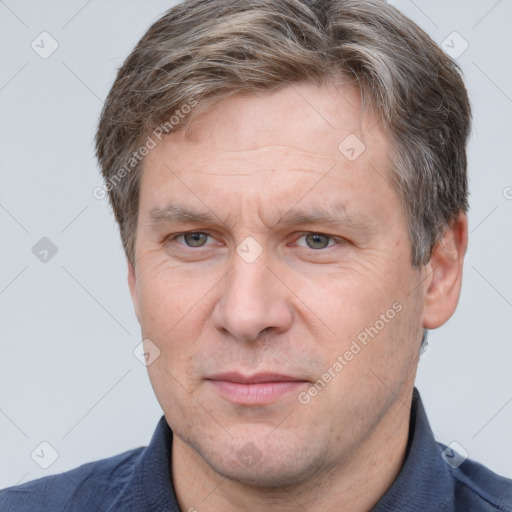 Joyful white adult male with short  brown hair and grey eyes