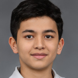 Joyful latino young-adult male with short  brown hair and brown eyes