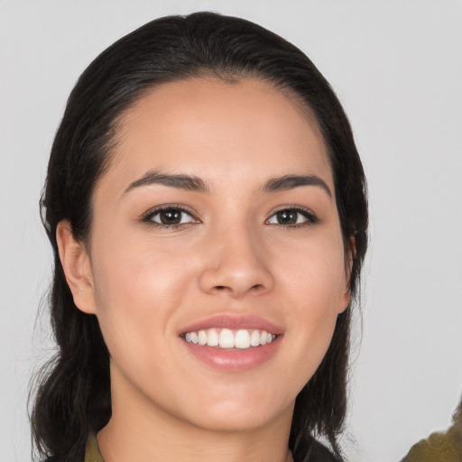 Joyful white young-adult female with long  black hair and brown eyes