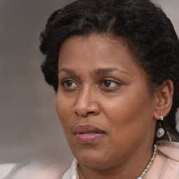 Joyful latino adult female with short  brown hair and brown eyes