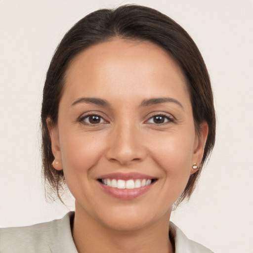 Joyful white young-adult female with medium  brown hair and brown eyes