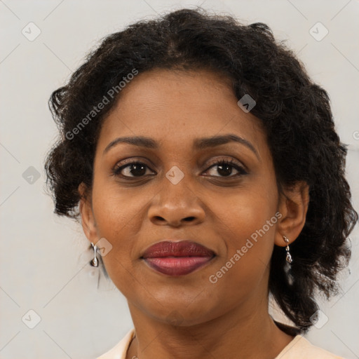 Joyful black adult female with medium  brown hair and brown eyes