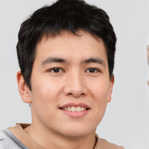 Joyful asian young-adult male with short  brown hair and brown eyes
